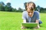 Young Boy Playing On Tablet Pc Stock Photo