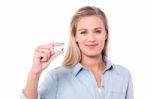 Smiling Woman With A Pill In Hand Stock Photo