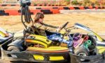 Little Girl Is Driving Go- Kart Car In A Playground Racing Track Stock Photo