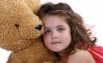 Child Hugging Teddy Bear Stock Photo