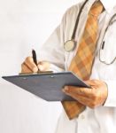 Doctor Writing On Pad Stock Photo