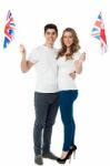 Cheerful Couple Waving The British Flag Stock Photo