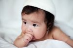 Newborn Sweet Baby With Fingers In Mouth Stock Photo