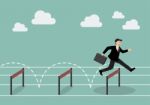Businessman Jumping Over Hurdle Stock Photo