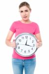 Casual Young Woman Holding A Clock Stock Photo