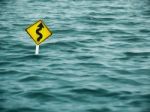 Yellow Sign Of Road In Water Stock Photo