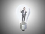 Businessman Trapped In Lightbulb Stock Photo