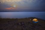 Camping Tent On Rock Mountain With Sun Rising On Dramatic Sky Stock Photo