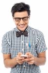 Cheerful Young Man Using Mobile Phone Stock Photo