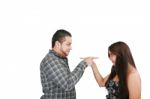 Young Couple Pointing At Each Other Against A White Background Stock Photo