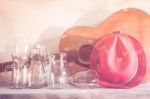 Acoustic Guitar And Assorted Glass Bottles On Wooden Table. Retro Style Stock Photo