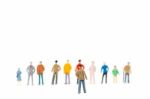 Group Of Miniature People Standing On White Background Stock Photo