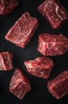 Raw Angus Beef Slices On The Black Stone  Table Vertical Stock Photo