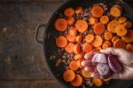 Adding Shallot In The Pan With Bacon And Carrots Top View Stock Photo