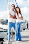Couple Crossing Arm At Harbor  Stock Photo