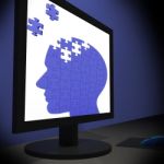 Head Puzzle On Monitor Showing Human Brightness Stock Photo