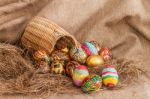 Colorful Painted Easter Egg In Wicker Basket On Hay Stock Photo