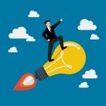 Businessman On A Moving Lightbulb Idea Rocket Stock Photo