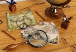 Vintage Maps And Magnifying Glass On Wood Table Stock Photo