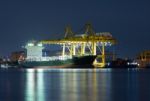 Container Cargo Freight Ship With Working Cranes Stock Photo