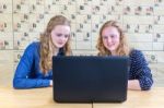 Two Teenage Girls Looking At Computer In Chemistry Lesson Stock Photo