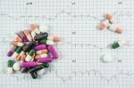 Heap Of Medicine Pills On Cardiogram Grid Paper. Selective Focus Stock Photo