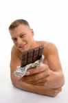 Smiling Man Showing Chocolate Stock Photo