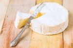 Camembert Cheese With Cut Wedge And Vintage Knife On Wooden Tabl Stock Photo
