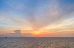 Sun Set At Sea With Blue Sky And Clouds Stock Photo