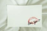 Sexy Red Lipstick Kiss 'love You' Heart On White Note On White Bed Pillow Sheet In The Morning Light, Valentine's Day Stock Photo