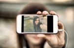 Young  Woman Taking A Photo With Her Phone Stock Photo