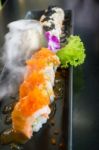 Salmon Sushi Served On Black Plate Stock Photo