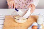 Woman Baking And Mixing Flour With Milk Stock Photo
