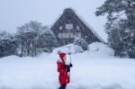 Young Woman In Shirakawa-go Village In Winter, Unesco World Heritage Sites, Japan Stock Photo