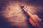 Violin On Grunge Dark Wood Background Stock Photo