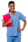 Female Nurse Holding Clipboard, At Duty Stock Photo