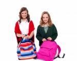 Smiling Girls Unzipping School Bag Stock Photo