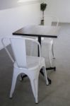 White Steel Chair And Wooden Table Stock Photo