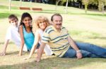 Young Family Relaxing In Park Stock Photo