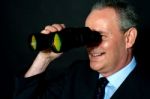 Businessman with binoculars Stock Photo