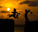 Concept Cartoon Silhouette, Man Hold Axe And  Man Jumping Over P Stock Photo
