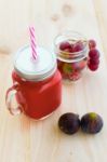 Strawberry Juice, Figs And Grapes On Wooden Background Stock Photo