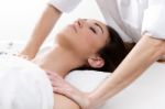 Woman Enjoying Shoulder Massage At Beauty Spa Stock Photo