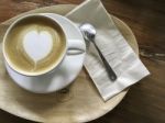 White Cup Of Heart Shape Cappuccino Coffee On Wood Plate Stock Photo
