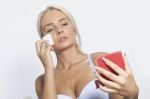 Young Woman Clean Face With Wet Wipes And Holding Mirror Stock Photo