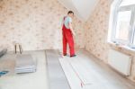 Handyman Laying Down Laminate Flooring Boards Stock Photo