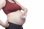 Pregnant Woman Holding Pills Stock Photo