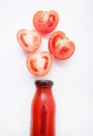 Tomatoes Juice In Bottle And Fresh Tomatoes Slices On White Wood Stock Photo