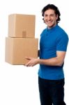 Smart Young Man Carrying Boxes Stock Photo