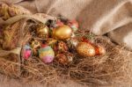 Colorful Painted Easter Egg And Fabric Bag On Hay Stock Photo